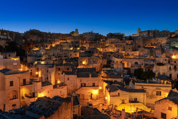 Fototapeta na wymiar view of the old town of Matera after sunset with the lights coming on