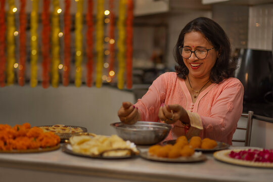 Senior woman making laddoo on the occasion of Diwali