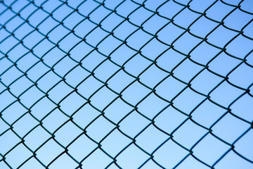 Fototapeta premium Chain Link Fence against a Clear Blue Sky