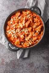 Chicken, bacon and banana bake Flygande Jacob closeup on the pan on the table. Vertical top view from above