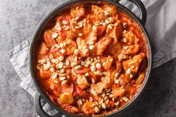 Creamy casserole Flygande Jakob made of chicken, cream, chilli sauce, bananas, roasted peanuts and...