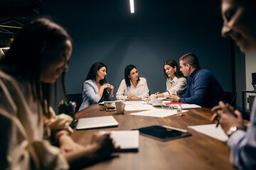 Architect sitting at boardroom on a meeting and discussing project.