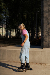 Middle-aged woman roller-skates in the city. Middle age entertainment.