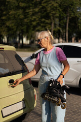 Middle-aged woman roller-skates in the city. Middle age entertainment.
