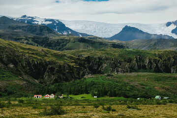 Small farms and homesteads under mountains and glaciers