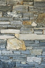 Vertical stone wall abstract masonry background pattern