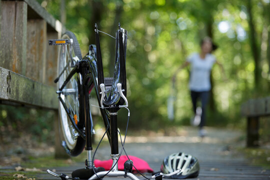 mountain biker fixing the bike chain on forest trail