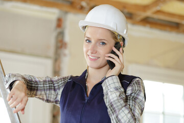 young engineer woman with safety helmet talking on phone