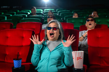 Old woman shocked with scary movie in theater