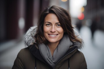 Portrait of a beautiful young woman in winter coat in the city