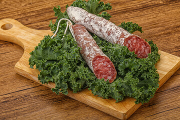Spanish Fuet sausage with salad leaves
