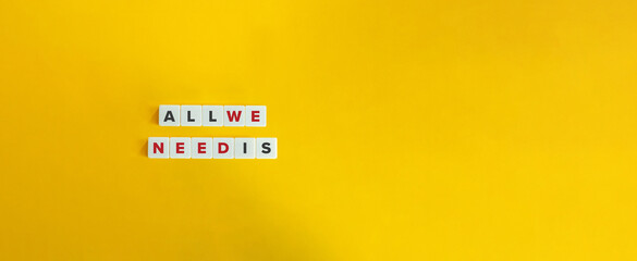 All We Need Is Phrase on Block Letter Tiles on Yellow Background. Minimal Aesthetic.