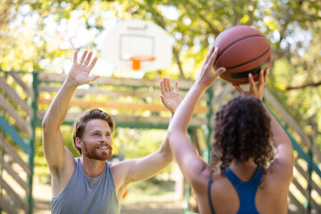 happy people playing basket outdoors