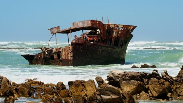 Rusted old shipwreck of Meisho Maru No 38 stuck on rocky coastline, Agulhas