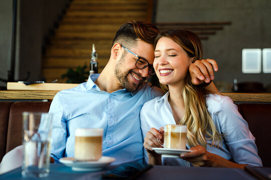 Romantic loving couple drinking coffee, having a date in the cafe.