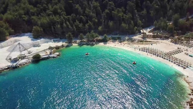 Porto Vathy in Thassos Island , Greece , well known tourist attraction at Aegean Sea , famous for it's pure white marble sand , surrounded by Mediterranean pine forest and turquoise clear water , aeri