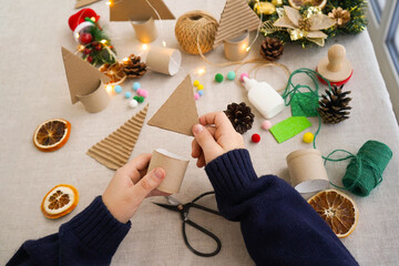 Step-by-step instructions on how to make a Christmas tree out of cardboard. Step 2 connect the...