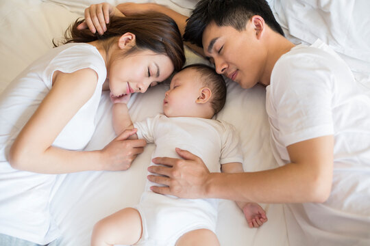 Young family sleeping in bed