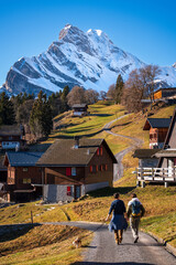 View of a couple of people during a walk in Braunwald, Switzerland