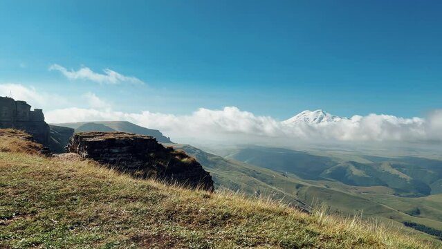 View of Elbrus and the ancient Amphitheater from the Bermamyt plateau. Caucasus 2023. A trip to Bermamyt, the Grand Canyon in Russia. Mountain landscape on a summer day. Karachay-Cherkessia. 4К