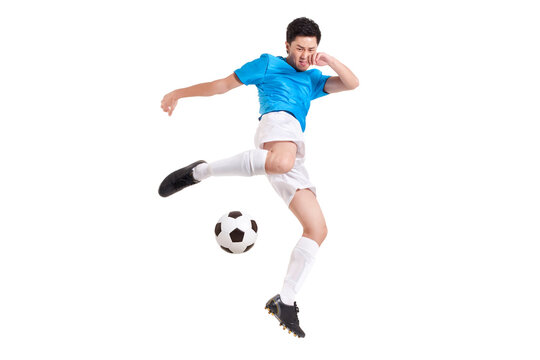 Fototapeta Soccer player kicking while jumping