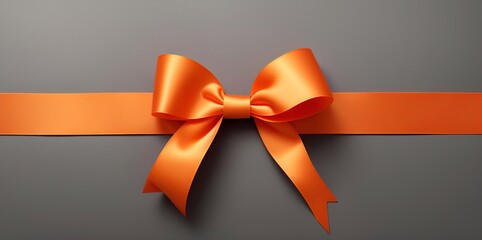 Top view of orange ribbon with a bow for a present, gift box on a gray background. Concept of Christmas, birthday, anniversary, Xmas, Valentine's Day, proposal