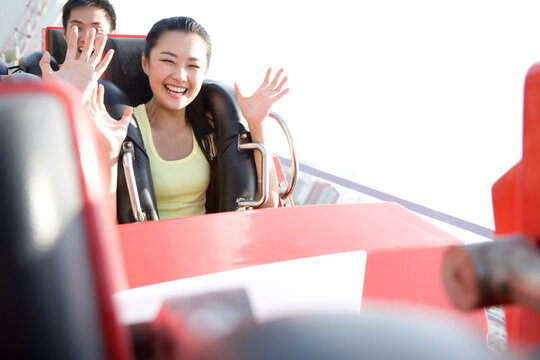 Young people riding a rollercoaster