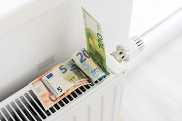 Banknotes for a heating radiator in the house. Central heating in the apartment. Economical consumption of resources.