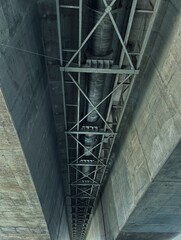 Obraz premium Pipes and steel frames under the bridge cool tone