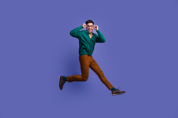 Fototapeta na wymiar Photo of cheerful positive man wear stylish clothes hurrying optics shop special black friday sale isolated on violet color background