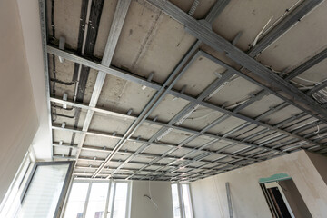 The metal frame of the ceiling, sound insulation, in the process of repairing an apartment