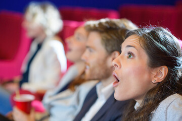 surprisde friends watching film in cinema