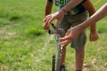Open water tap in a garden in summer
