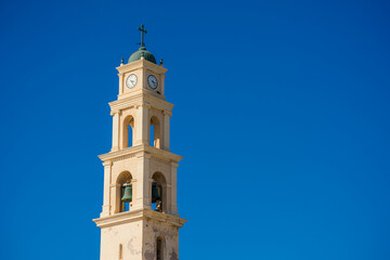 Bell tower of St. Peter's church in Jaffa, Israel, against the blue sky