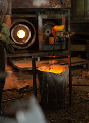 Foundry ladle with molten metal in workshop of metallurgical plant