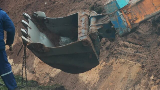 auto excavator with rotary bucket and telescopic boom digs a hole to replace the pipeline, industry