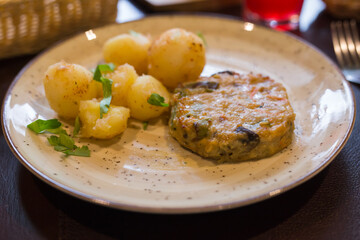 Vegetable cutlet with boiled potatoes on a plate