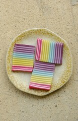 Layered and colorful cake slices with top angle view. Traditional cake made from rice flour and coconut milk. Kue lapis