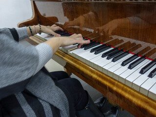 Pianist playing piano, classical music - reflection of hands and keyboard