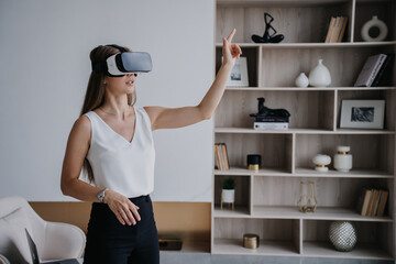 Blonde American girl using virtual reality headset as an educational tool, hi tech. Pretty young...