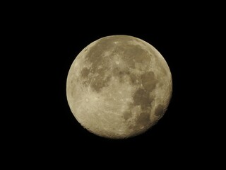 Super moon with craters on a black background. Space for text