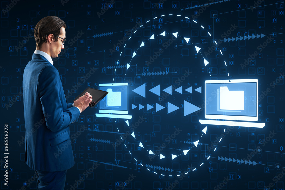 Aufkleber Attractive young businessman using digital pad with creative digital data transfer and exchange folders on dark background. Backup data, virtual document storage or loading on cloud service.
