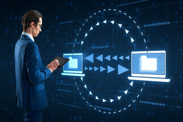 Attractive young businessman using digital pad with creative digital data transfer and exchange...