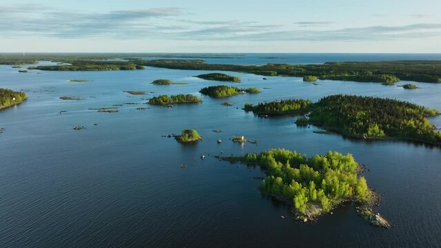 Drone shot of lush green islands in the archipelago of Finland, summer sunset