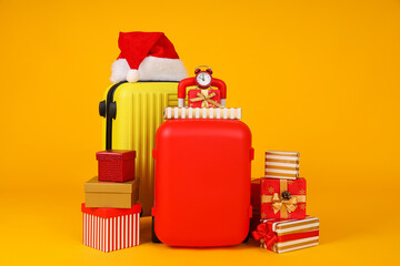 Suitcases with a New Year's hat and gifts