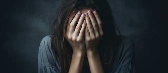 Woman hiding face in desperation copy space image