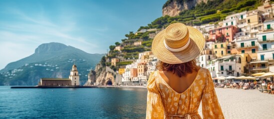 Tourist girl admires stunning Amalfi Coast in Italy copy space image