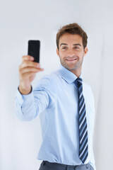 Naklejka premium Happy businessman, selfie and social media for photography, memory or online vlog at office. Handsome or attractive man or employee smile for photograph, picture or business fashion at workplace