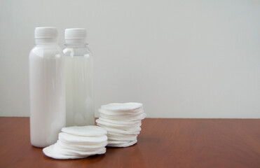 Cosmetic products and cotton pads.White cosmetic bottle mockup. Skin care concept.