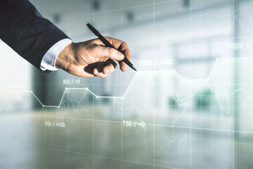 Double exposure of male hand with pen working with abstract creative statistics data hologram on blurred office background, analytics and forecasting concept
